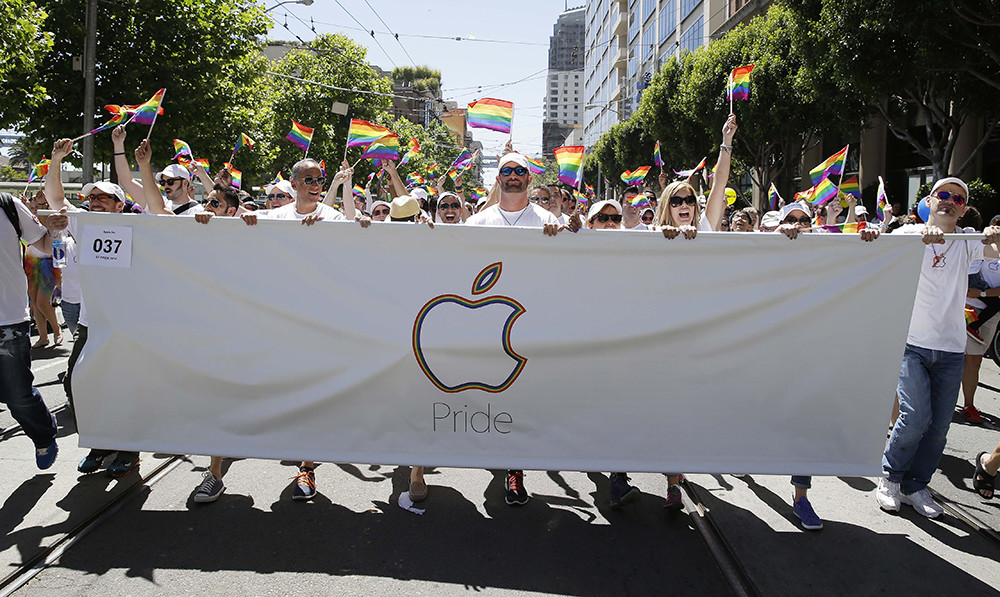 Apple Computer employees and family members march during the 44th annual San Francisco Gay Pride parade Sunday, June 29, 2014, in San Francisco. The lesbian, gay, bisexual, and transgender celebration and parade is one of the largest LGBT gatherings in the nation. (AP Photo/Eric Risberg)