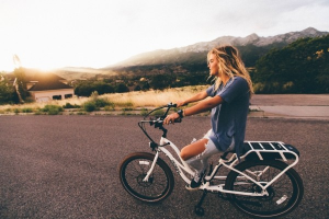 2-young-woman-riding-bicycle-on-asphalt-road