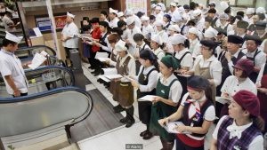 C681CW Japan Tokyo Shinjuku Shinjuku Station restaurant employees servers cooks chefs uniforms morning meeting before work daily instru
