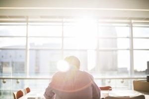 man-sitting-at-desk-in-office-and-reading-documents