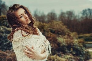 portrait-of-beautiful-young-woman-with-crossed-arms-contemplating