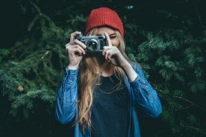young-woman-in-red-knit-hat-photographing