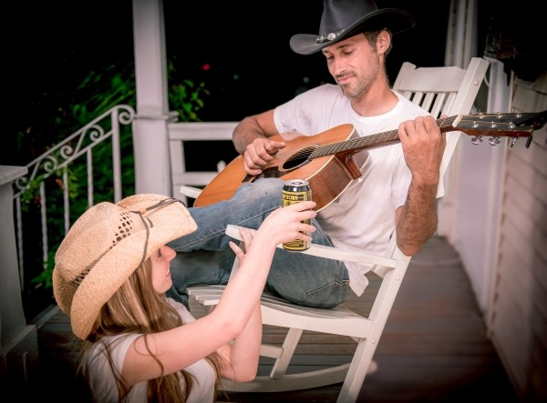 friends-relaxing-on-porch-drinking-beer-and-playing-guitar