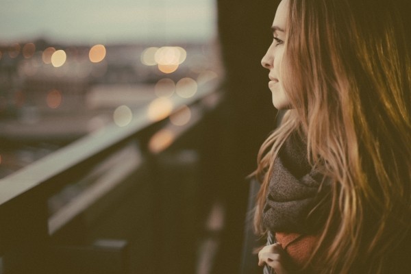 smiling-woman-looking-at-city-lights