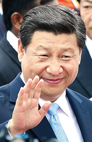 China's President Xi Jinping gestures during a welcome ceremony at the Bandaranaike International Airport in Katunayake on September 16, 2014. President Xi Jinping arrived in Sri Lanka September 16 where he will launch construction of a Chinese-backed $1.4 billion port city as he promotes his vision of a "maritime silk road" in the face of growing competition from Japan and India. AFP PHOTO / LAKRUWAN WANNIARACHCHI