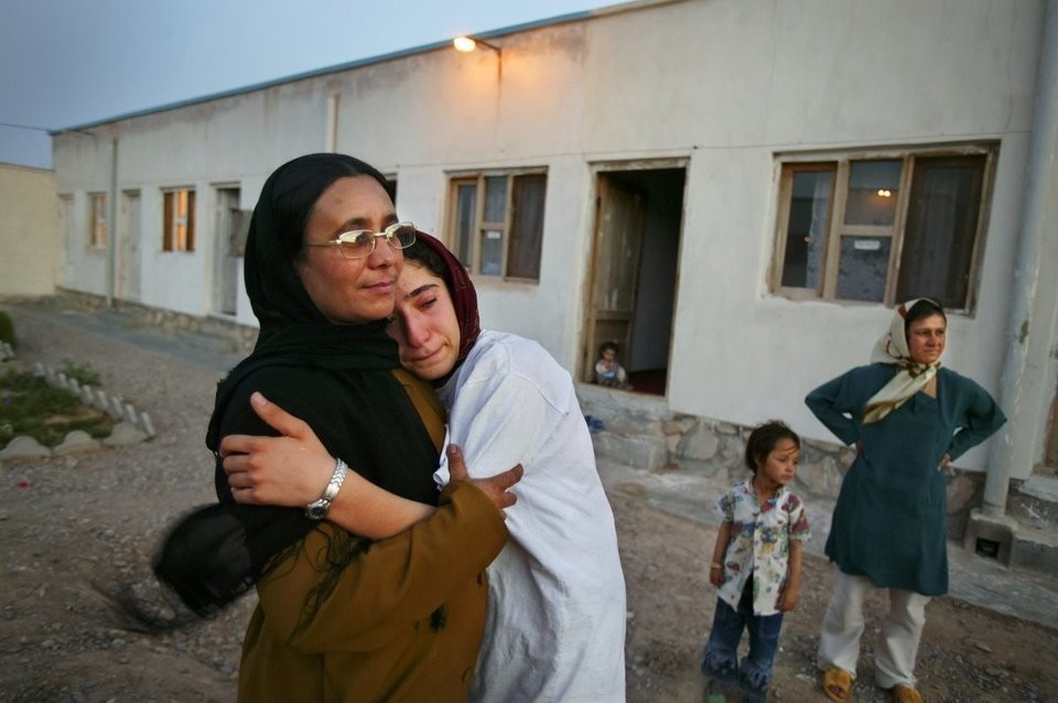 Mejgon, 16, weeps in the arms of her caseworker near fellow residents at an NGO shelter run by Afghan women in Herat, Afghanistan. Mejgons father sold her at the age of 11 to a 60-year-old man for two boxes of heroin.