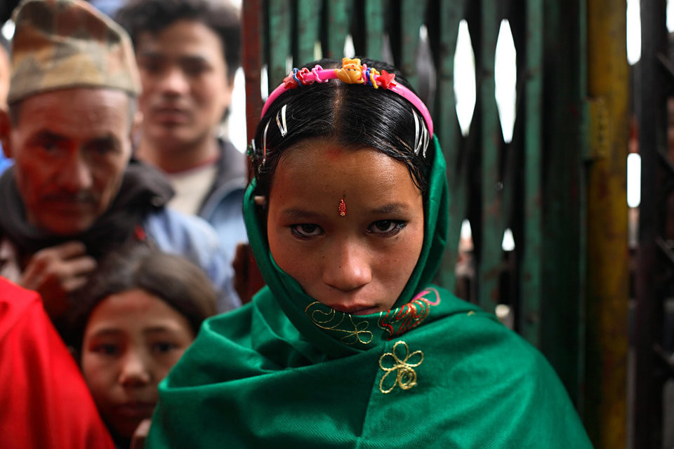 A nine-months pregnant Niruta, 14, arrives at the wedding ceremony in Kagati Village, Kathmandu Valley, Nepal on Jan. 23 ,2007. Niruta moved in with the family of Durga, 17, and became pregnant when they were only engaged. In some circles of the more socially open Newar people, this is permissible. ropensity towards this practice.