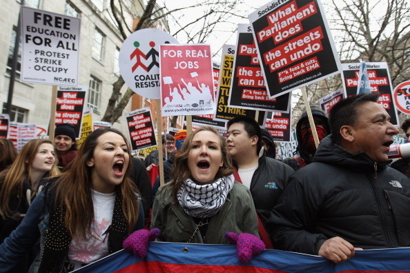 LONDON, UNITED KINGDOM - JANUARY 29: Student demonstrators march to Parliament to protest against the Government's cuts to public services and an increase in tuition fees on January 29, 2010 in London, England. A simultaneous protest is due to take place in Manchester both will be attended by students, union activists and tax avoidance campaigners. (Photo by Oli Scarff/Getty Images)